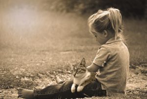 girl outside, cat on lap