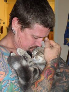 man holding kitty in arms