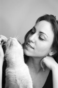 head of woman, scratching cat's face