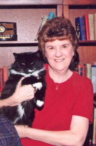 lady in red sweater holding black cat
