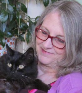 woman holding black cat