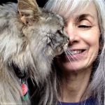 Silver-haired woman with silver-haired cat