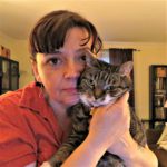 Woman holding tabby cat