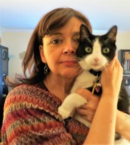 Woman holding black & white cat
