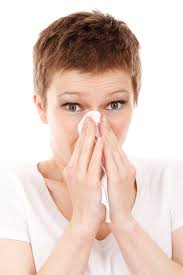 Person holding tissue to nose