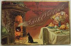 Thanksgiving scene: cat by fire; table set