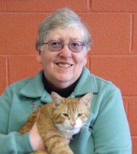 woman holding ginger cat