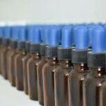 Row of brown tincture bottles; blue tops