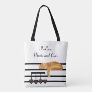 Orange tabby lying on music staff tote