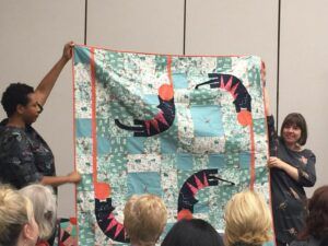 whimsical cats on blue & white quilt