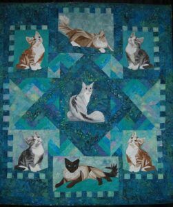 Realistic cat pics in quilt squares, lots of blue