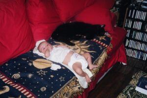 Cat lying next to baby