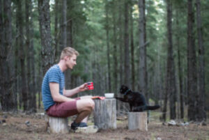 Man and cat camping