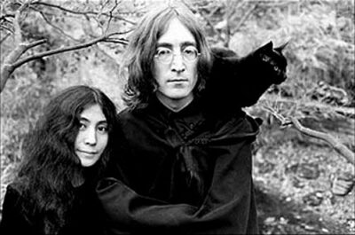 John Lennon & wife with black cat