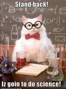 White cat saying, "Stand back! Is goin to do science!