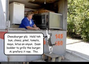 Cat on stool on hind legs in front of hamburger stand